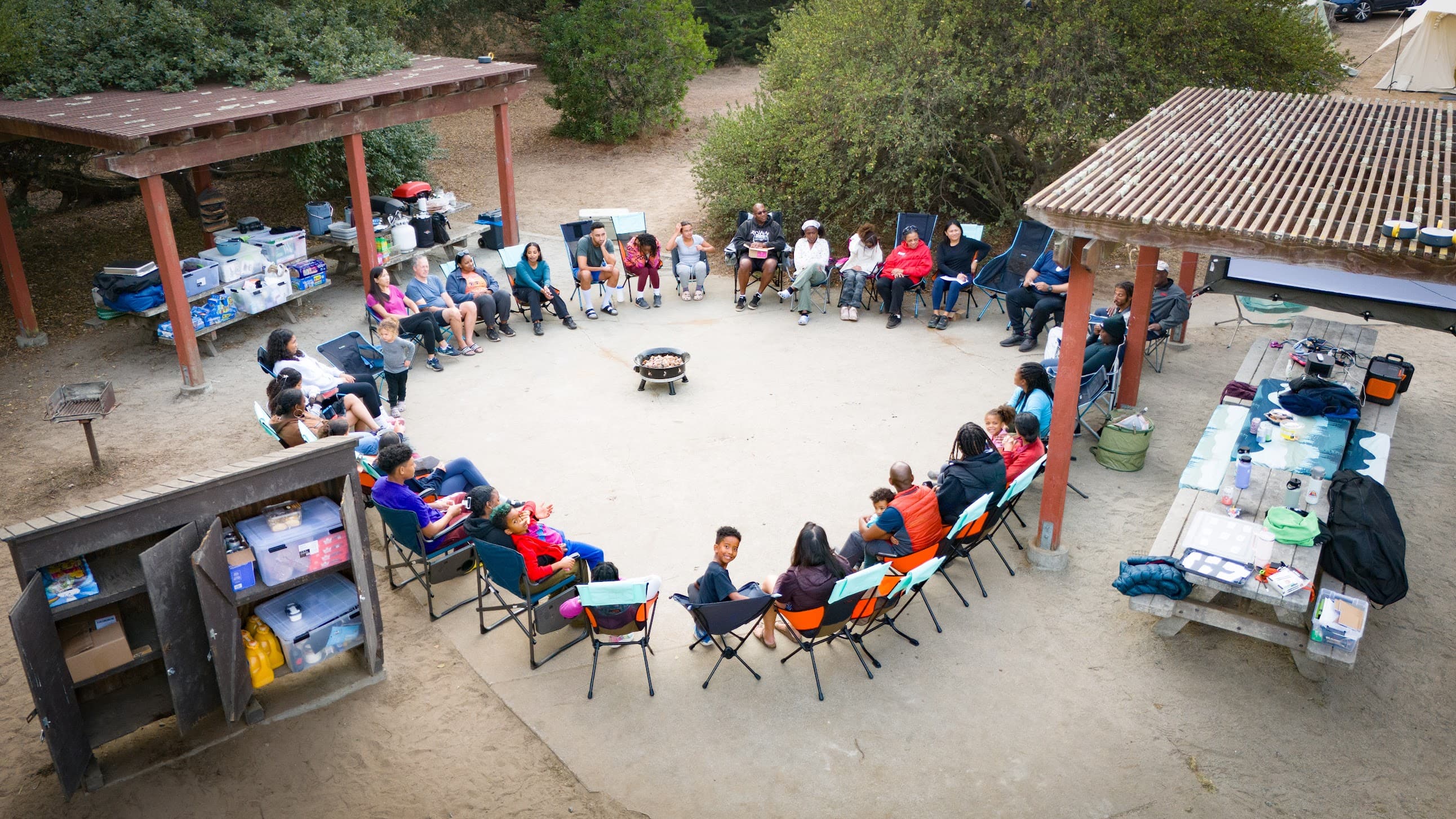 Families gathered in a circle at camp