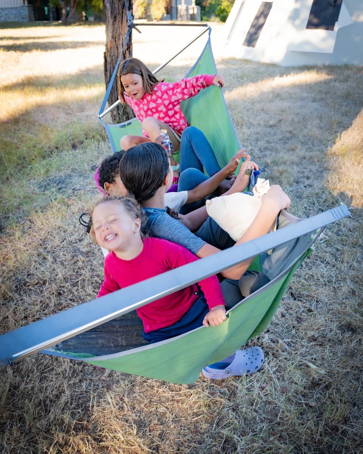 Kids laughing together in hammocks