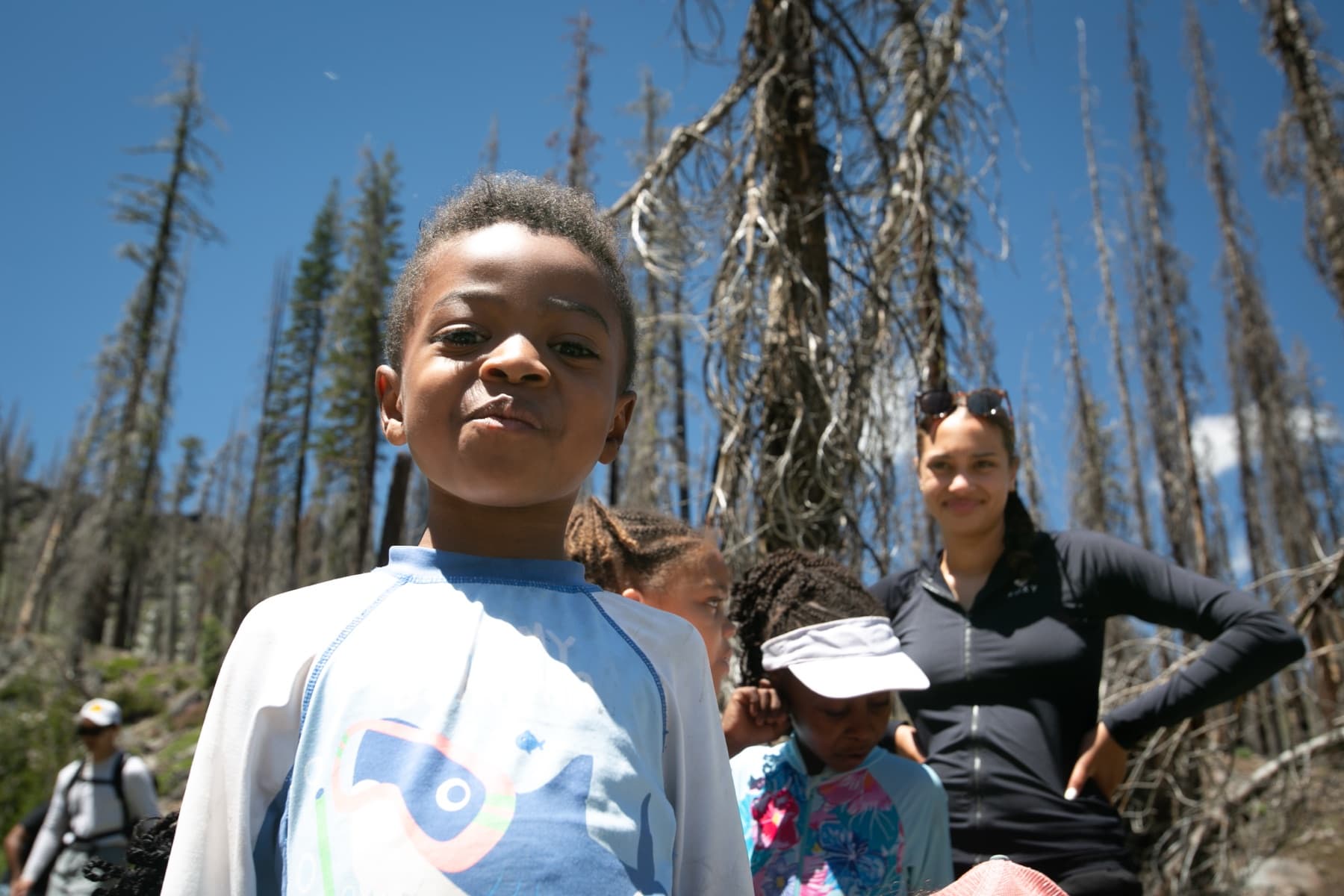 A group of children and adults hiking a trail together at Lassen Volcanic National Park