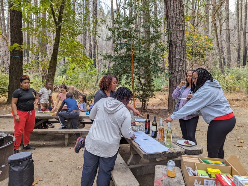 Adults wine tasting and sharing appetizers while pizzas cook